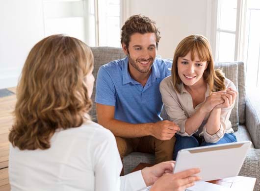 Happy young man and woman consulting plans digital PC real estate apartment